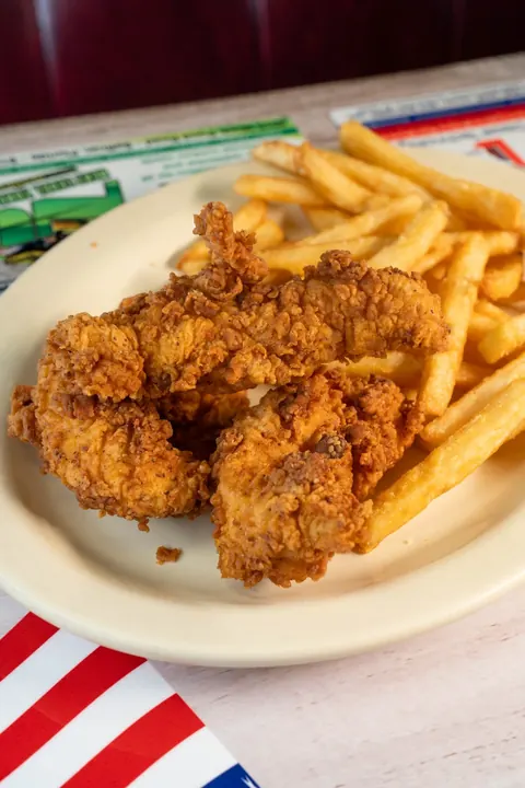 Golden chicken tenders served with fries